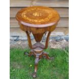 A Victorian Walnut Work Table. The foliate marquetry lid over a shaped frieze with pendant drops (