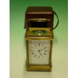 A French Brass Carriage Clock. The enamel mask dial with Roman numerals, the 8 day movement with