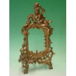 A Gilt Metal Photograph Frame cast and pierced in the rococo taste with female form, putto and