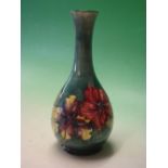 Moorcroft Pottery. A Hibiscus tube-lined baluster vase. Bears paper label. 10 ¼" high