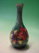 Moorcroft Pottery. A Hibiscus tube-lined baluster vase. Bears paper label. 10 ¼" high