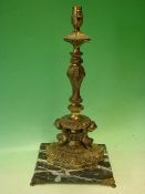 A Gilt Brass Table Lamp. Neo-classical form, raised on a marble base and paw feet. 17" high