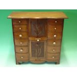 A Walnut Jewellery Chest with two flights of six drawers, flanking two cabinets each enclosed by a