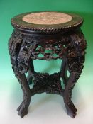 A Chinese Hardwood Stand. The beaded pink marble inset top above a carved and pierced apron of birds