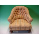 A Victorian Child's Tub Armchair with deep-buttoned back, raised on turned walnut feet (minor