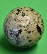 An early smooth gutty golf ball with some strike marks but in good round condition and some original