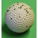 Red dot 'The Colonel' bramble pattern rubber core golf ball with the patent number to the opposite