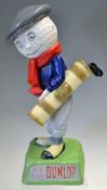 Later Resin Dunlop Caddie figure c/w 3x removable golf clubs on splayed naturalistic base