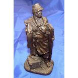 BRONZE FIGURE: Cast bronze figure of an angler holding a pike, with rod holdall and creel, stands