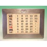 A Silver Desk Calendar The engine turned frame with initialled cartouche, enclosing the celluloid