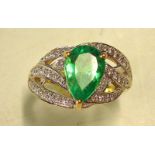 An Emerald and Diamond Ring With a pear shaped Columbian emerald weighing approximately 2cts. In