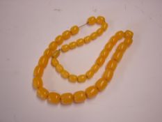 An Amber Necklace Strung with graduated yellow beads. 70g. Condition report: All good