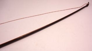 A Victorian English Longbow Constructed from two hardwoods, with velvet grip. 63 ½" long.