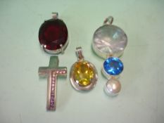 Four Silver Pendants Each set with semi - precious or paste stones, one with a natural pearl. Height