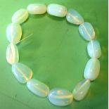 A Moonstone Bangle Of fourteen beads. Condition report: All good, re-strung