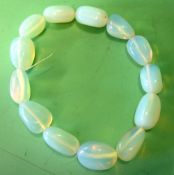 A Moonstone Bangle Of fourteen beads. Condition report: All good, re-strung
