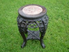 A Chinese Hardwood Stand The beaded pink marble inset top above a carved and pierced apron of