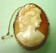 A Shell Cameo Brooch. Carved as a young lady looking left in a gold frame. 2" high. Condition