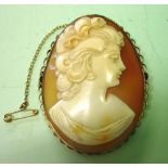 A Shell Cameo Brooch. Carved as a young lady looking left in a gold frame. 2" high. Condition