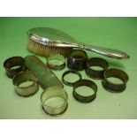 Nine Various Silver Napkin Rings Together with a silver hair brush and a silver brush back. 5.4ozs