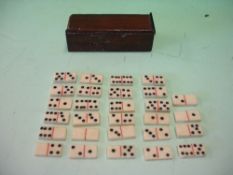 A Miniature Domino Set The twenty eight bone pieces in a mahogany box with sliding cover. 19th