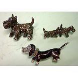 An Enamel Dachshund Brooch Set with marcasite and marked BJL verso, together with two silver Scottie