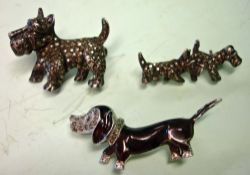 An Enamel Dachshund Brooch Set with marcasite and marked BJL verso, together with two silver Scottie