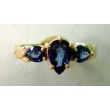 A Ceylon Sapphire Three Stone Ring With pear shaped stones. In gold marked 375. Condition report: