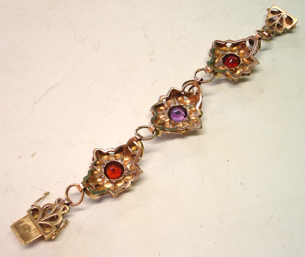 A 14ct Gold Bracelet Formed as three linked flower heads, set with an amethyst and two smoky - Image 2 of 2