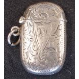 A Silver Vesta Case Of oval form and engraved with foliage and initials to the cartouche, 1 5/8"