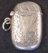 A Silver Vesta Case Of oval form and engraved with foliage and initials to the cartouche, 1 5/8"