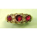 A George V Ring Set with three rubies and four old cut diamonds. In 18ct gold and date marked for