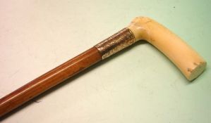 An Edwardian Malacca Cane With ivory grip and scroll chased gilt metal collar with engraved