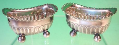 A Pair of Silver Salts Of half fluted form with crimped rims, raised on ball feet. Maker: James