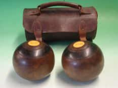 A Pair of Turned Lignum Vitae Carpet Bowls By Thomas Taylor, Glasgow. Leather case. Condition