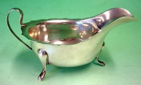 A Silver Sauce Boat Of helmet form with shaped rim. 5" long excluding handle. Sheffield 1950.