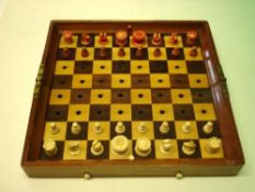 A Jaques In Statu Quo Travelling Chess Set With white and red stained carved bone pieces and