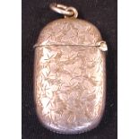 A Silver Vesta Case Of oval form and engraved with leaves, a vacant cartouche to one side. 1 5/8"
