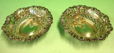 A Pair of Silver Bonbon Dishes With embossed and pierced decoration. 3 ¾" wide. Birmingham 1904.
