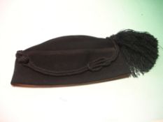 A Royal Household Black Forage Hat Scottish, late Victorian or Edwardian. Black felt with corded
