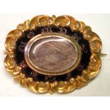 A Victorian Mourning Brooch Of Gothic revival form, with braided hair and enamel centre typically