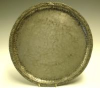 Hugh Wallis 1871-1943 A pewter charger, the folded rim with punched decoration. Stamped monogram.