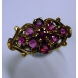 A 9ct Ring With nine pink stones in an openwork setting. 2.4g Condition report: All good