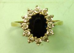 A Sapphire and Zircon Ring In a cluster setting. In gold marked 375. Condition report: All good