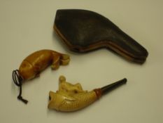 A Meerschaum Cheroot Carved as a catfish surmounted by a female figure, 3 ½" long; together with a