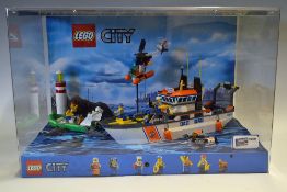 Lego Shop Display featuring Lego City No 60014 Coast Guard Set all house in a plastic display case