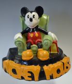 Mickey Mouse plaster cast figure featuring Mickey Mouse sitting in a arm chair with bold lettering