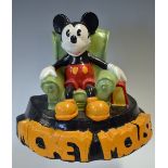 Mickey Mouse plaster cast figure featuring Mickey Mouse sitting in a arm chair with bold lettering