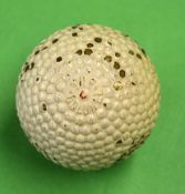 The Colonel Red Dot bramble pattern rubber core golf ball with the patent number to the opposite