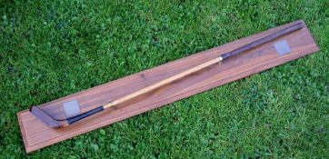 A Macleod beech wood replica longnose putter mounted on a presentation teak display board c/w